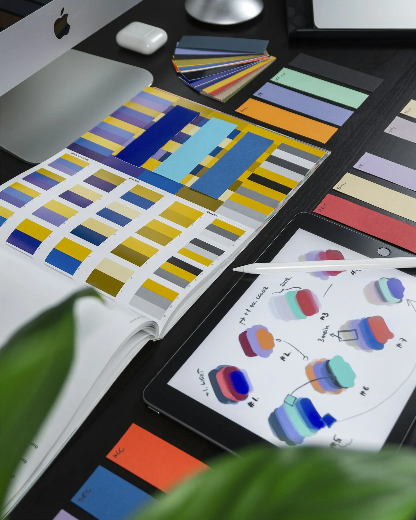 Colour swatches and design sketches on a designer's desk Colour swatches and design sketches on a designer's desk