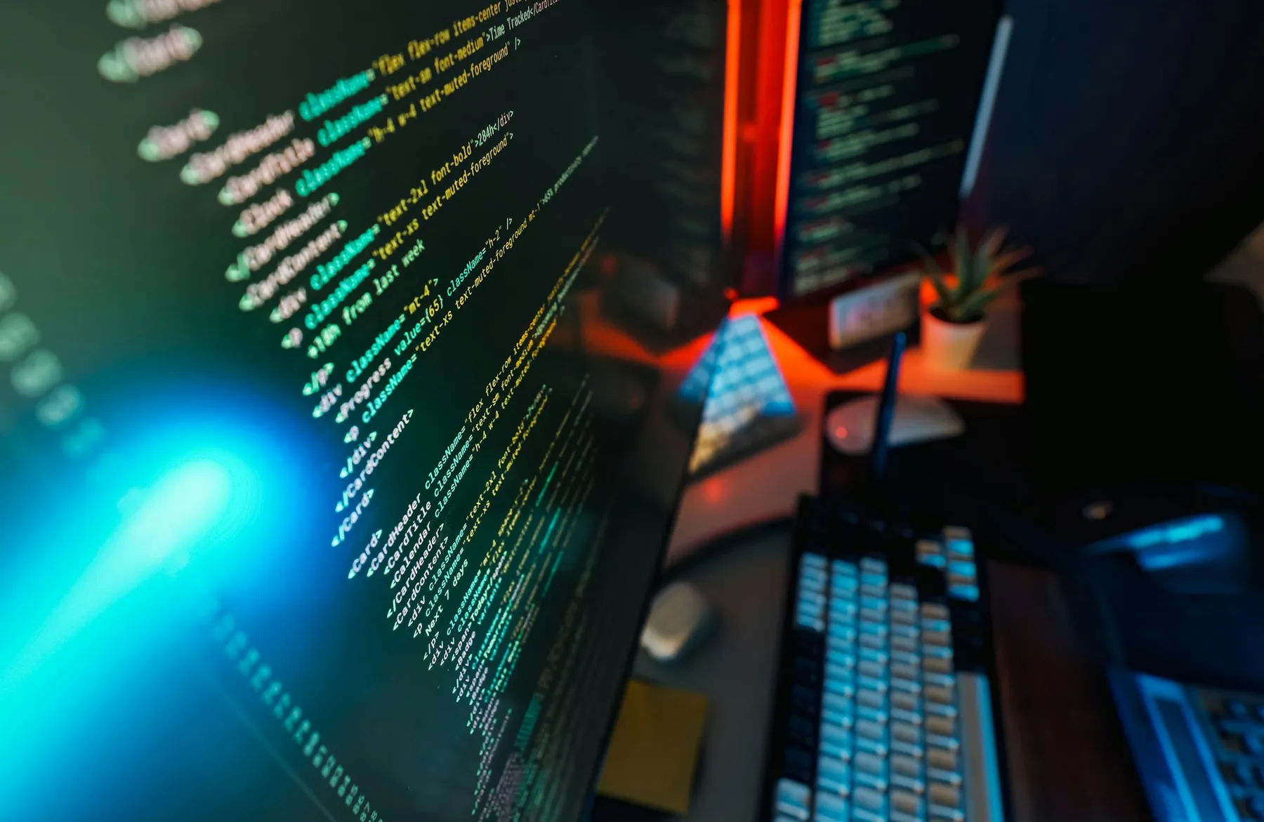 Close-up of colorful programming code on a monitor in a moody tech workspace