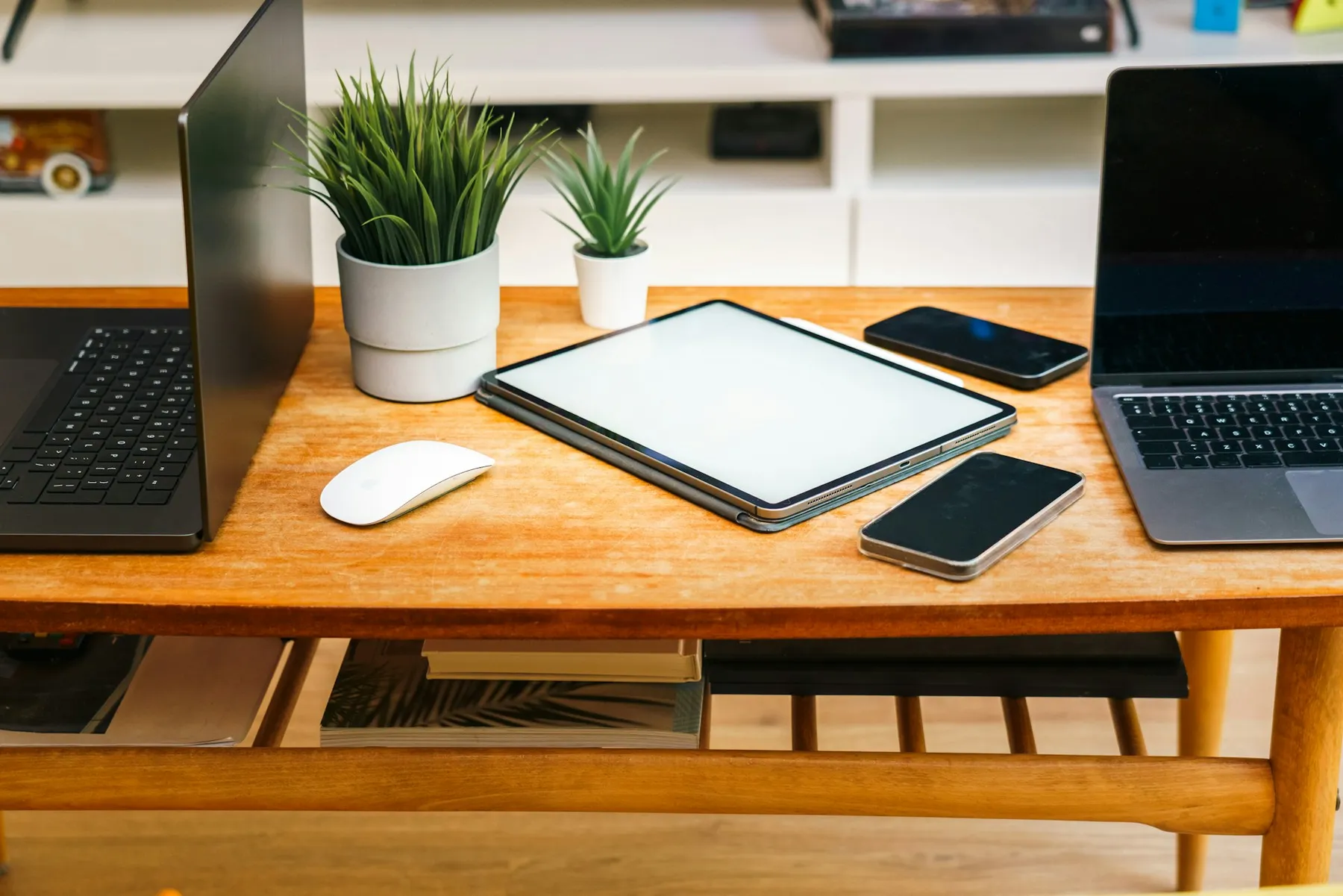 Laptop, tablet, and smartphone arranged together on a desk representing multi-discipline digital work Laptop, tablet, and smartphone arranged together on a desk representing multi-discipline digital work