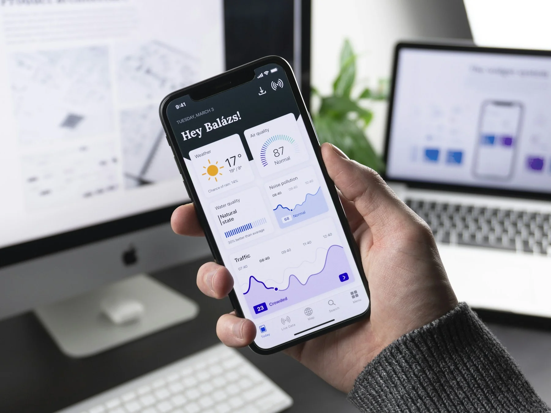 Hand holding a phone showing a custom mobile app dashboard Hand holding a phone showing a custom mobile app dashboard