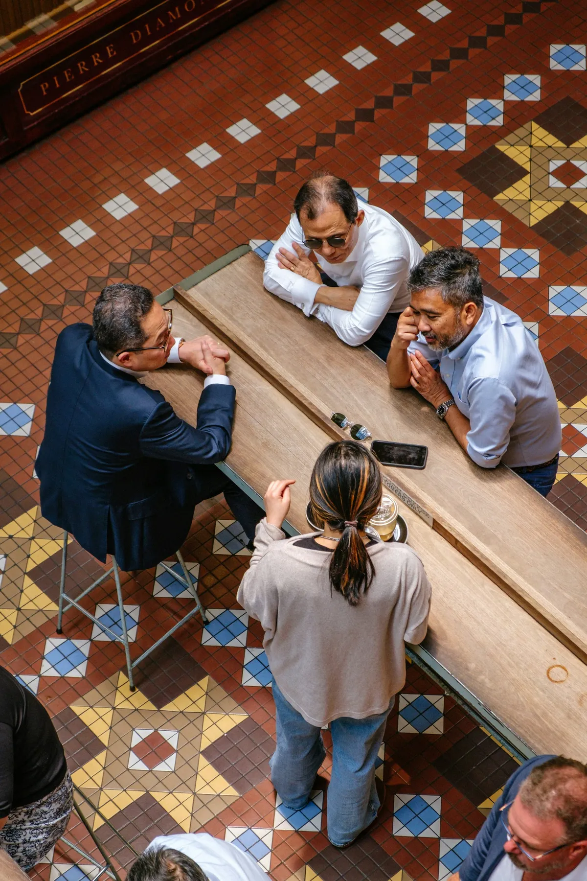 Colleagues gathered around a table in an open, collaborative discussion Colleagues gathered around a table in an open, collaborative discussion