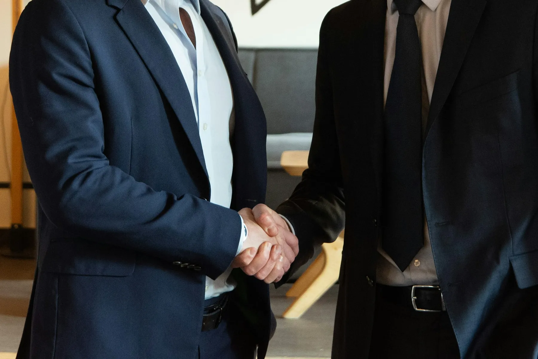 Two business partners shaking hands warmly in agreement Two business partners shaking hands warmly in agreement